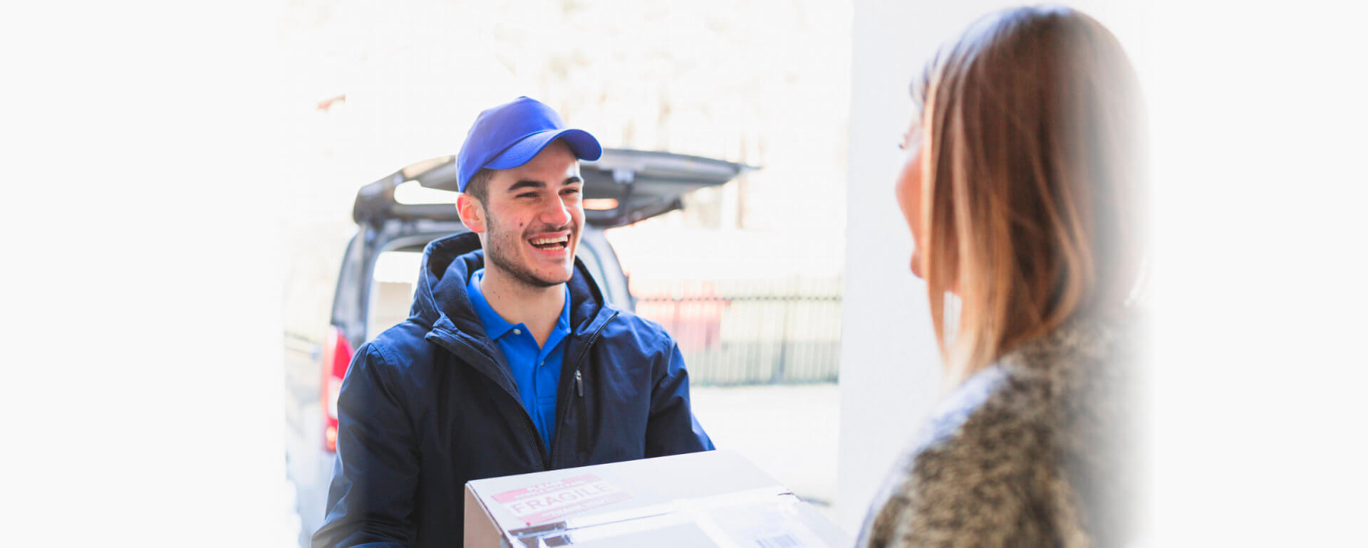 happy delivery man delivering package to the customer